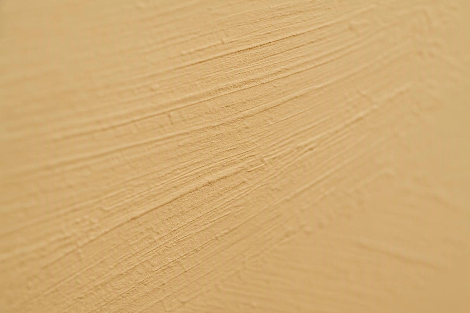 Close-up of a pale wooden surface showing fine grain and soft diagonal texture